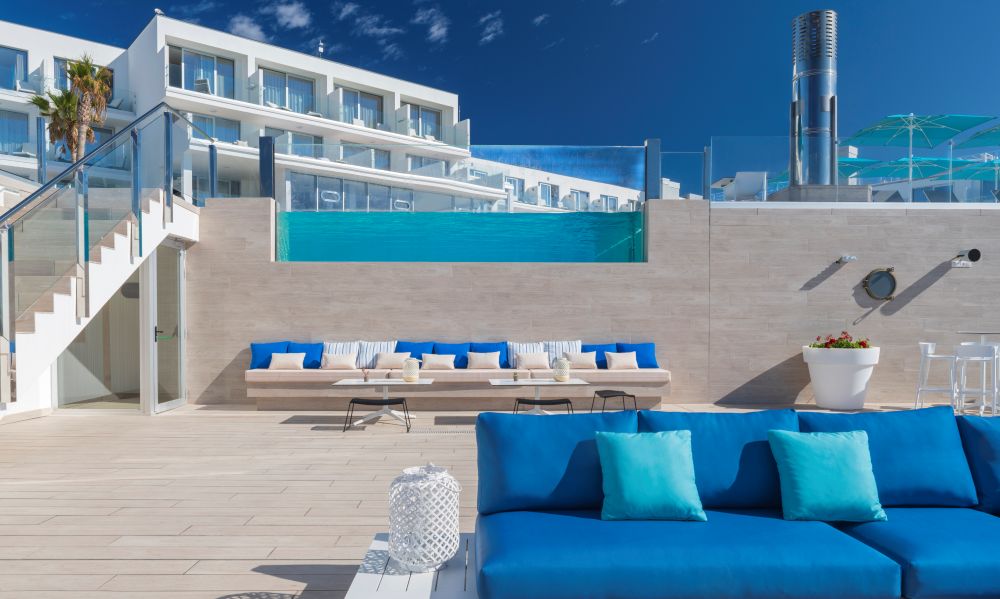 Blue seats on terrace with turquoise cushions at Elba Sunset Mallorca Thalasso Spa Hotel
