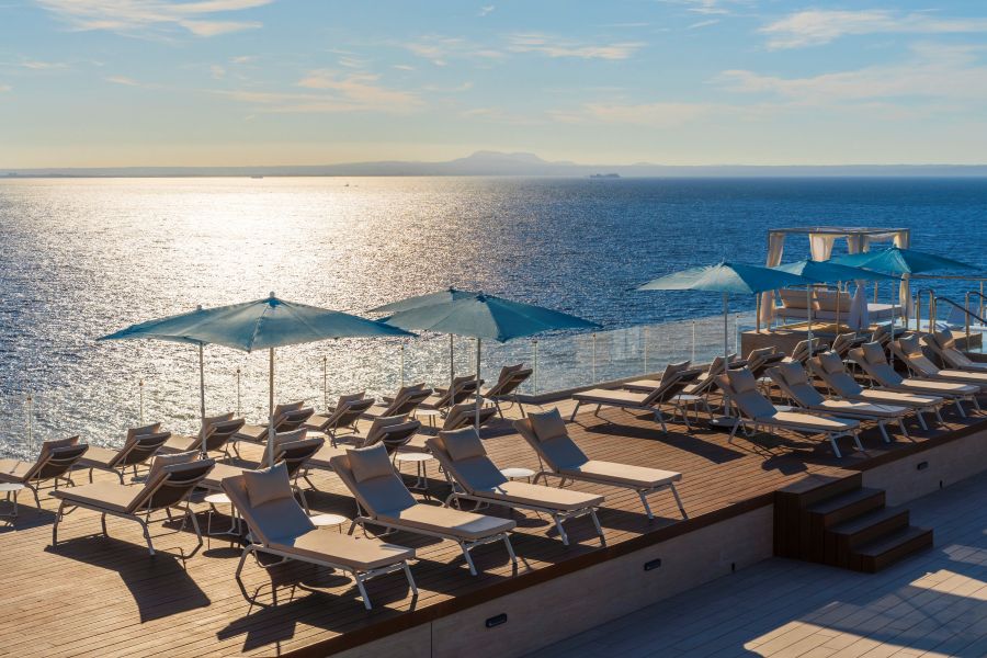 Parasols over sun loungers as sun sets in the distance at Elba Sunset Mallorca Thalasso Spa Hotel