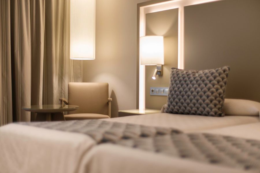 Chair in corner and pillow on bed at Spring Hotel Vulcano