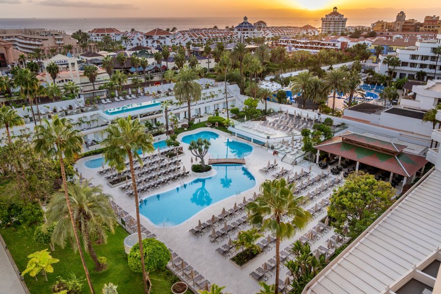 Swimming pools with sun loungers and palm trees surrounding at Spring Hotel Vulcano
