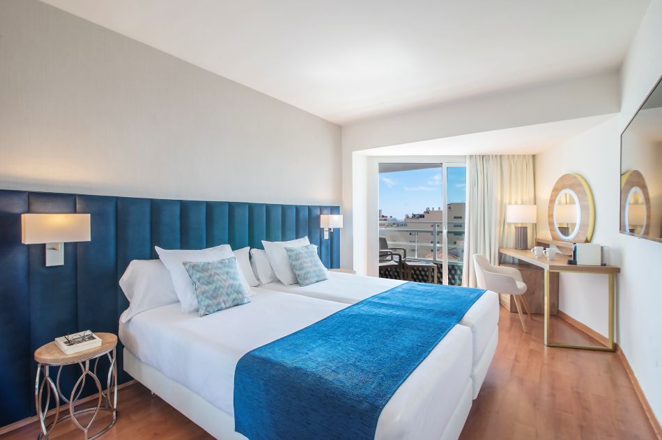 Bedroom with blue headboard at Hotel Costa Malaga