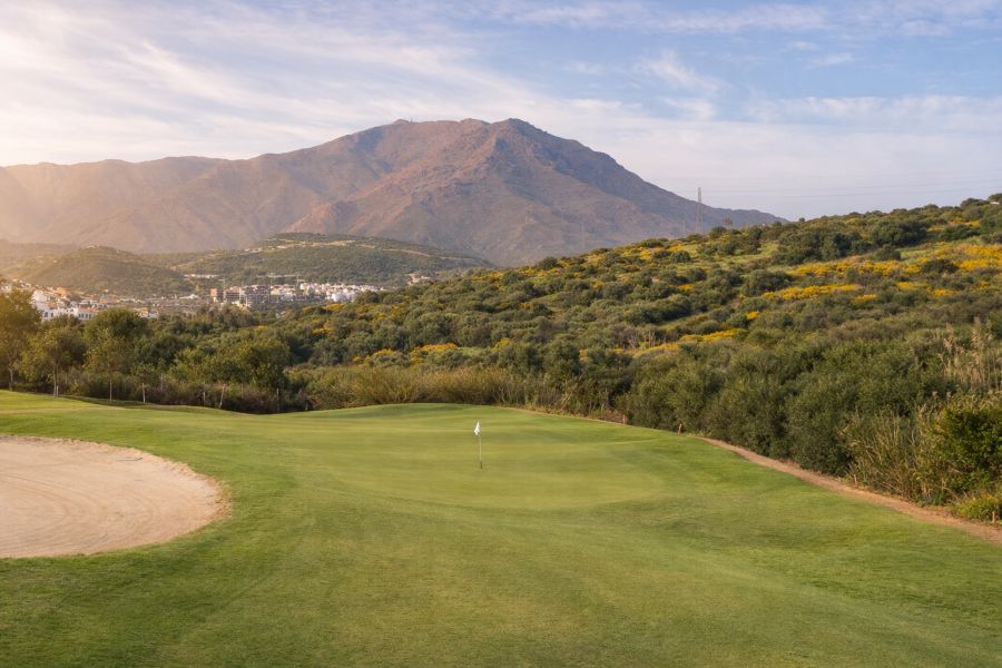 Mountain view behind the putting green at 16th hole at Azata Golf